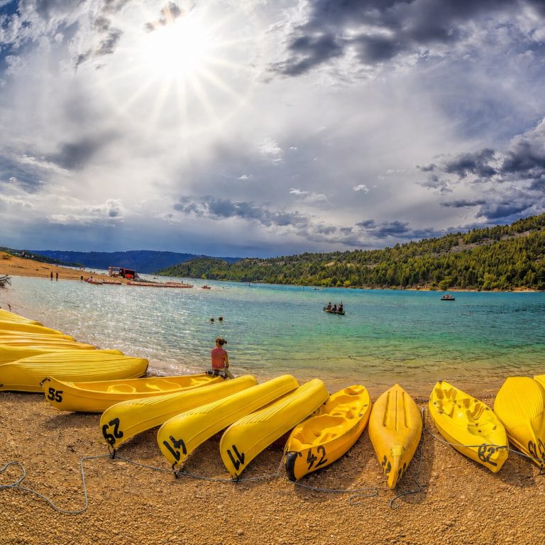 Kayaks jaunes installés sur la plage du Galetas au lac de Sainte-Croix